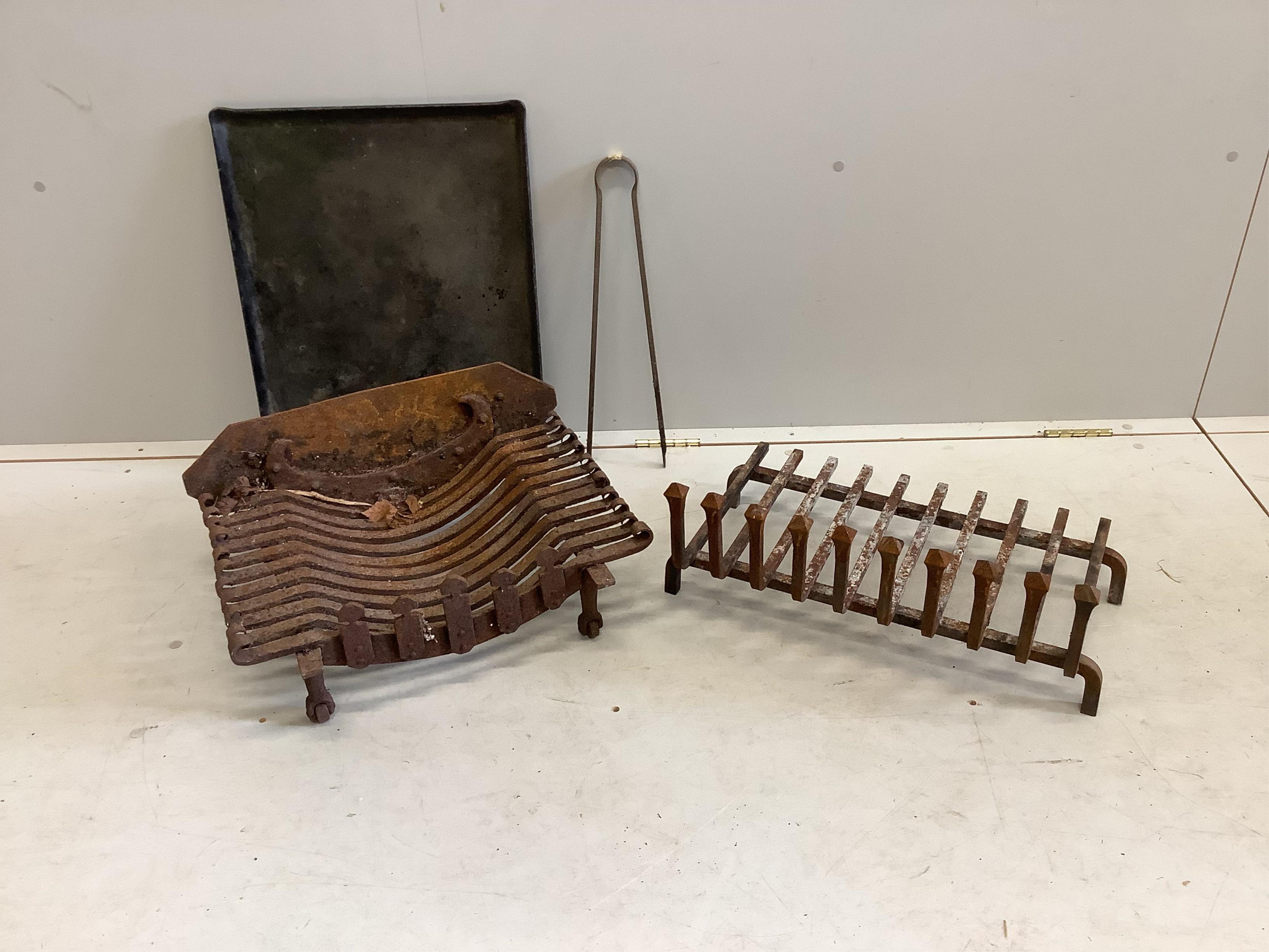 Two wrought iron fire grates, an ash pan and a pair of tongs, larger width 51cm, depth 39cm. Condition - fair